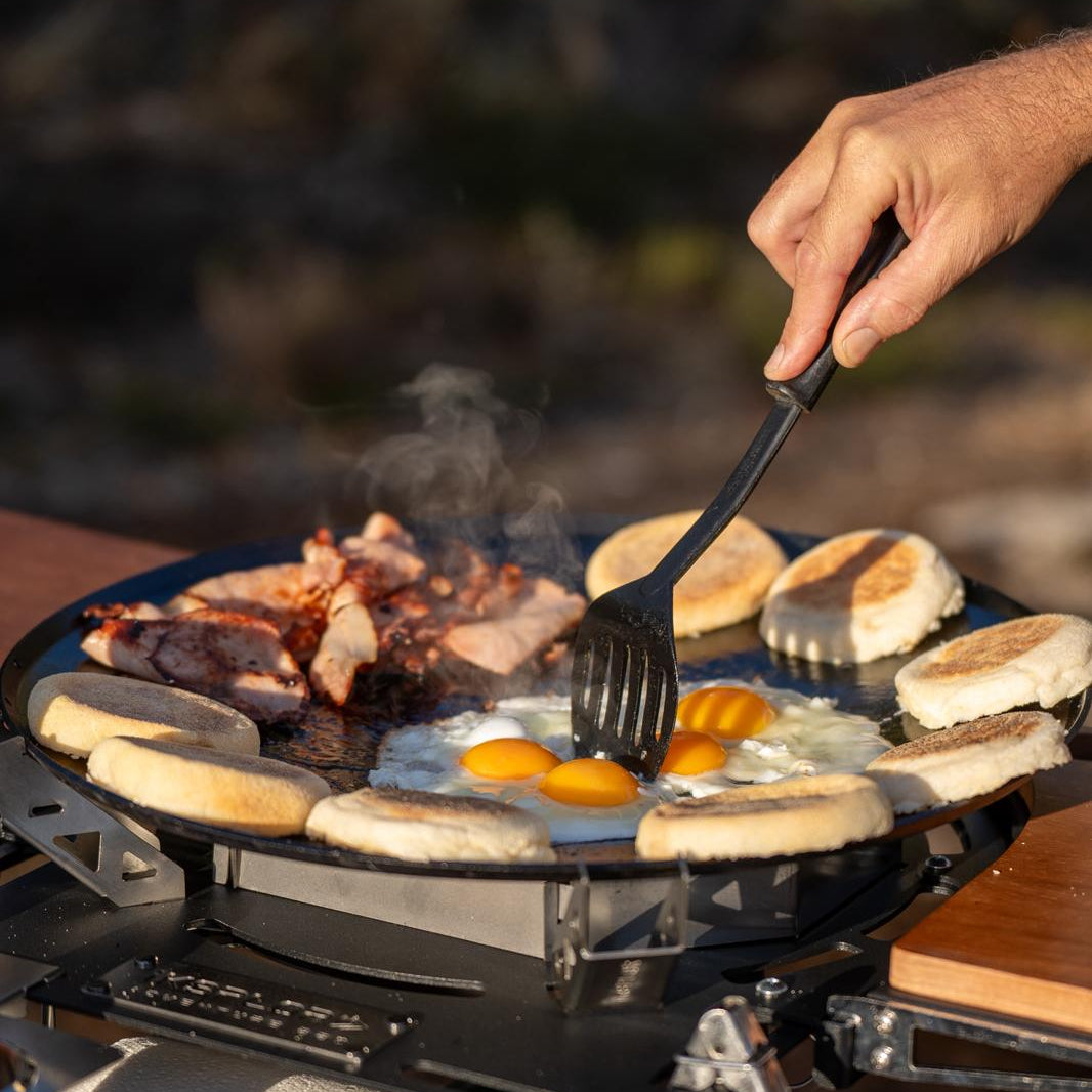 Cooking breakfast on a portable camping BBQ off-grid